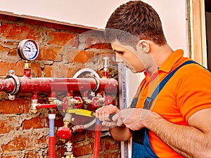 Men builder fixing heating system