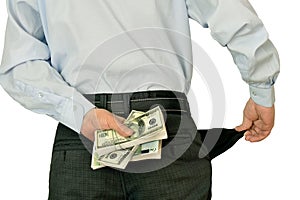 Men businessman showing empty pockets hiding behind wads of money photo