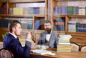 Men with busy faces drink tea. Men in suits, professors