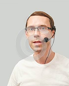 Men in call center. White t-shirt. Headset for telemarketing