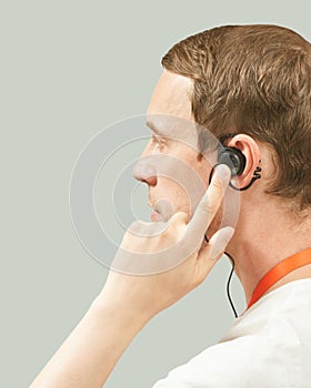 Men in call center. White t-shirt. Headset for telemarketing