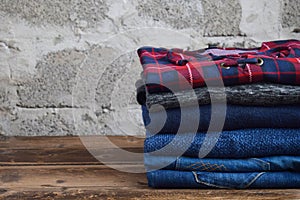 Men casual outfit. Men& x27;s shoes, clothing and accessories on wooden background - sweater, jeans. Top view. Flat lay