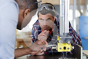 men check production data at factory