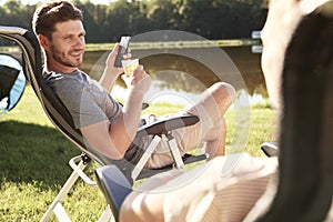 Men chilling on camping by the lake