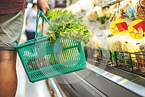 Men choosing fruits and vegetables in basket filled healthy food at supermarkets, ready-to-eat food, shopping