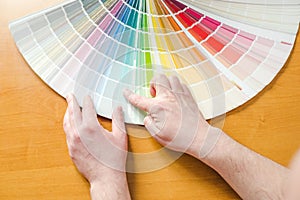 Men choosing paint color for home interior design project. top view