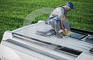 Men Cleaning Camper Van RV Roof Installed Solar Panels