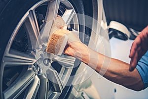 Men Cleaning Car Alloy Wheel