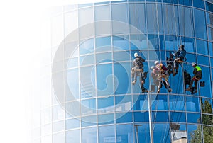 Men cleaning glass building. high-rise, industrial alpinism
