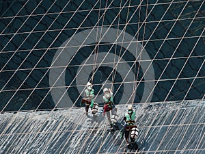 Men cleaning glass building