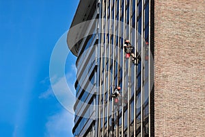 men cleaning the windows of a building