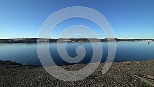 Men on coast and water surface of Arctic Ocean on New Earth Vaigach Island.