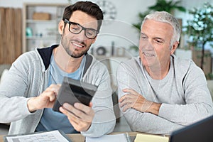 men crunching numbers working on finances photo