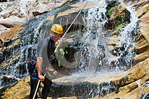 Men descending waterfall