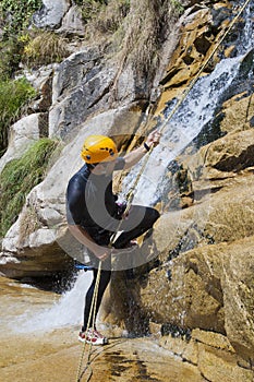 Men descending waterfall