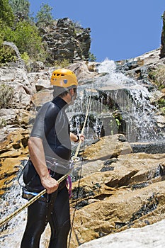 Men descending waterfall