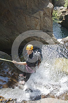 Men descending waterfall