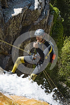Men descending waterfall