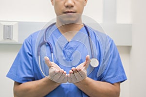 Men doctor show hand stetoscope on the neck selective focus hand