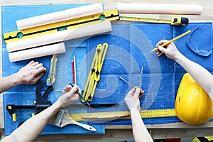 Men draftsmen on table draw construction project