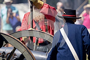 Soldiers by a cannon during a Civil War reenactment