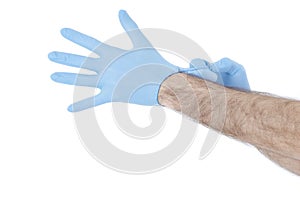 Men is dressing his hand in gloves. Isolated on white background