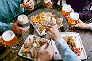 Men Drinking Beer And Eating Food Closeup