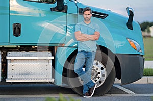 Men driver near lorry truck. Man owner truck driver in t-shirt near truck. Handsome middle aged man trucker trucking