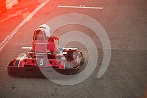 Men driving Go-kart car with speed in a playground racing track.