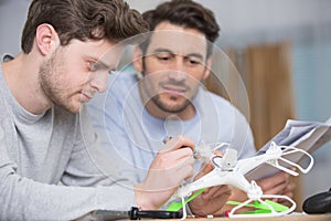 men with drone in hand