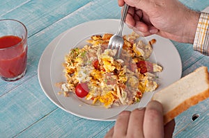 Men eating breakfast scrambled eggs