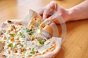 Men eats tasty pizza with Gorgonzola and pear. Baked in Traditional wood oven in Naples restaurant, Italy. Original