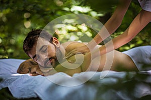 Men enjoy at back massage. Close up.