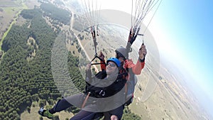 Men enjoying while paragliding