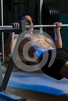 Men Exercising Back On Horizontal Barbell Pull Up