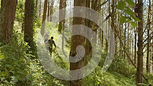 Men exercising running through the forest