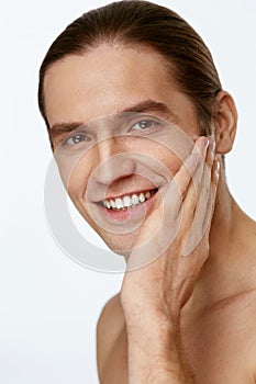 Men Face Care. Man Touching Smooth Skin After Shaving