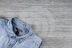 Men Fashion, Blue jeans shirt on a brown wooden background.