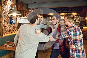 Men fight in a pub bar.