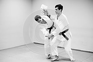 Men fighting at Aikido training in martial arts school