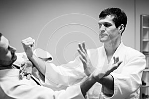 Men fighting at Aikido training in martial arts school