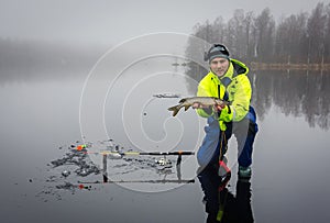 Men fishing pikes on ice