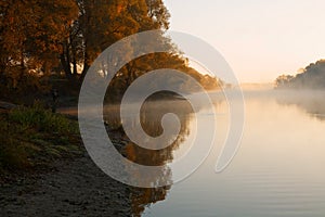 Men fishing in river with fly rod during summer morning. Beautiful fog