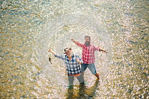 Men fishing in river during summer day. Family and generation - summer holidays and people concept. Man fishing and