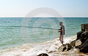 Men fishing in sea of Azov photo