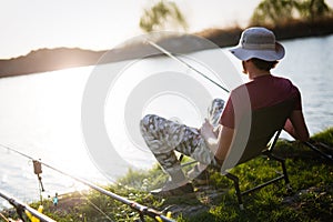 Men fishing in sunset and relaxing while enjoying hobby