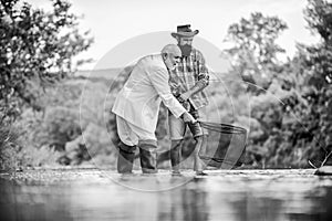 Men fishing together. Fish with friend. Male leisure. Good angler respects natural resources. Fish should never be