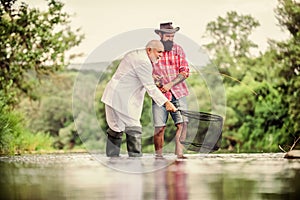 Men fishing together. Fish with friend. Male leisure. Good angler respects natural resources. Fish should never be