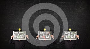 Men in formal gesturing with labyrinth