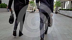 Men in formalwear carrying leather briefcases, quality accessories for business